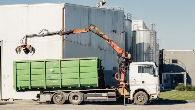 Truck with “polibenne” container and claw for industrial waste management