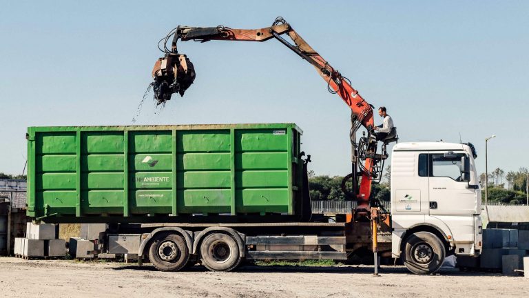 Truck with “polibenne” container and claw in operation in the management of Industrial Waste