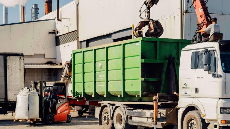 Truck with “polibenne” container and forklift in operation in the management of Industrial Waste